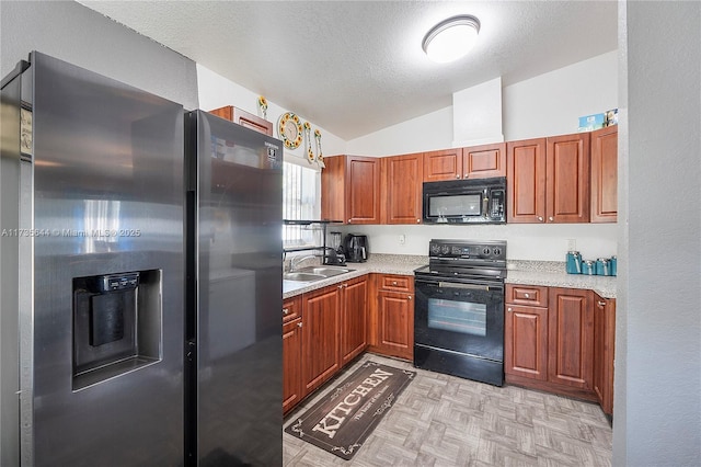 kitchen featuring lofted ceiling, sink, a textured ceiling, and black appliances