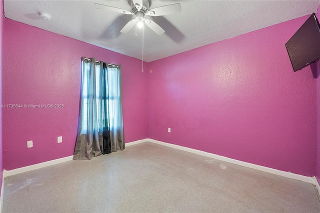 empty room featuring ceiling fan and a textured ceiling