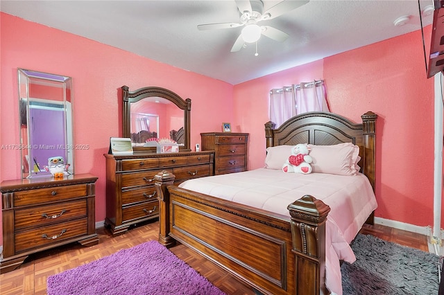 bedroom with ceiling fan and light parquet floors