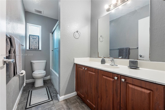 full bathroom with bath / shower combo with glass door, vanity, and toilet