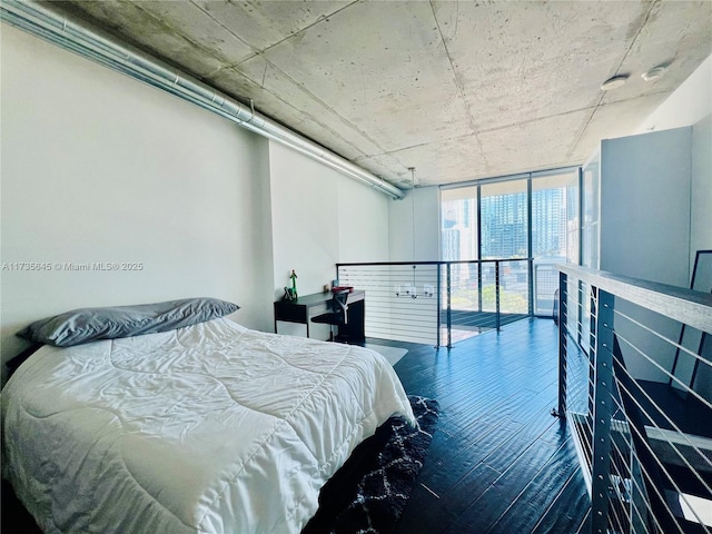 bedroom with dark wood-type flooring and floor to ceiling windows