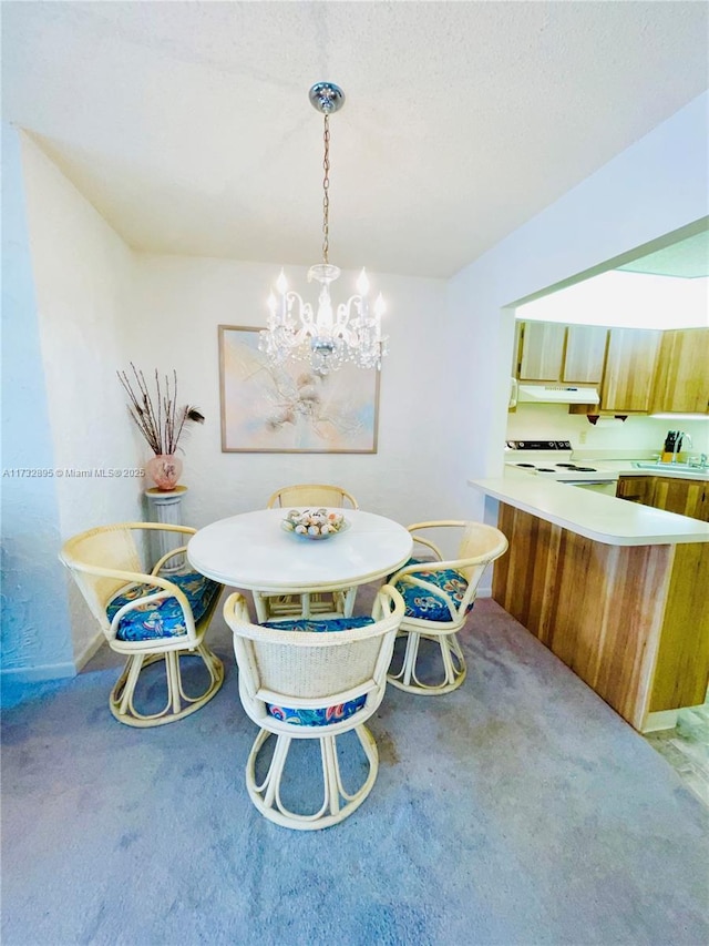 dining space featuring a notable chandelier, light colored carpet, and sink