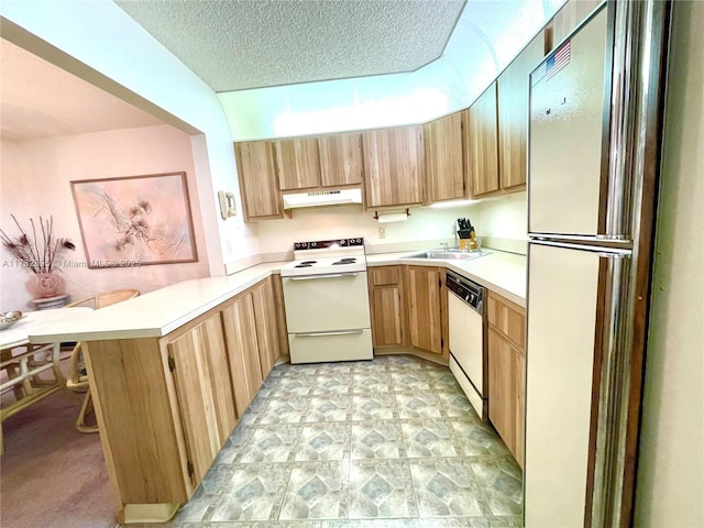 kitchen with sink, white appliances, kitchen peninsula, and a textured ceiling