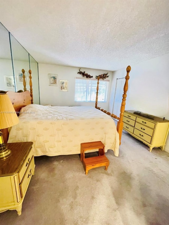 bedroom featuring carpet floors and a textured ceiling