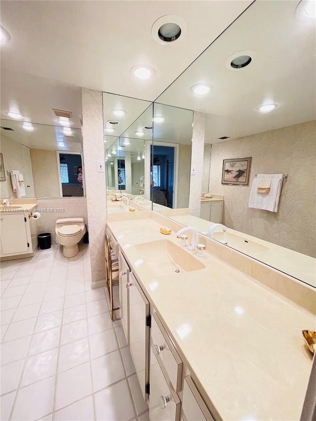 bathroom with tile patterned flooring, vanity, and toilet