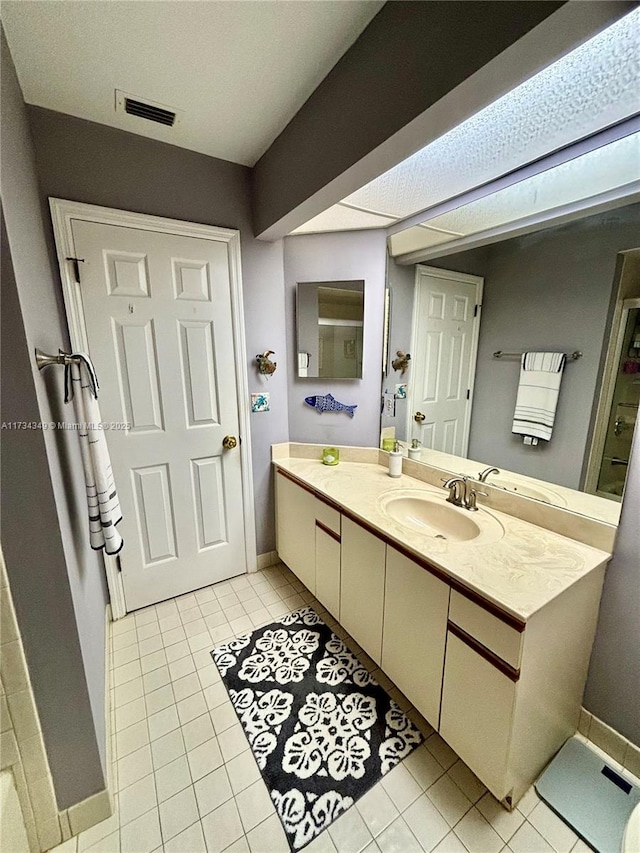 bathroom with vanity and tile patterned flooring