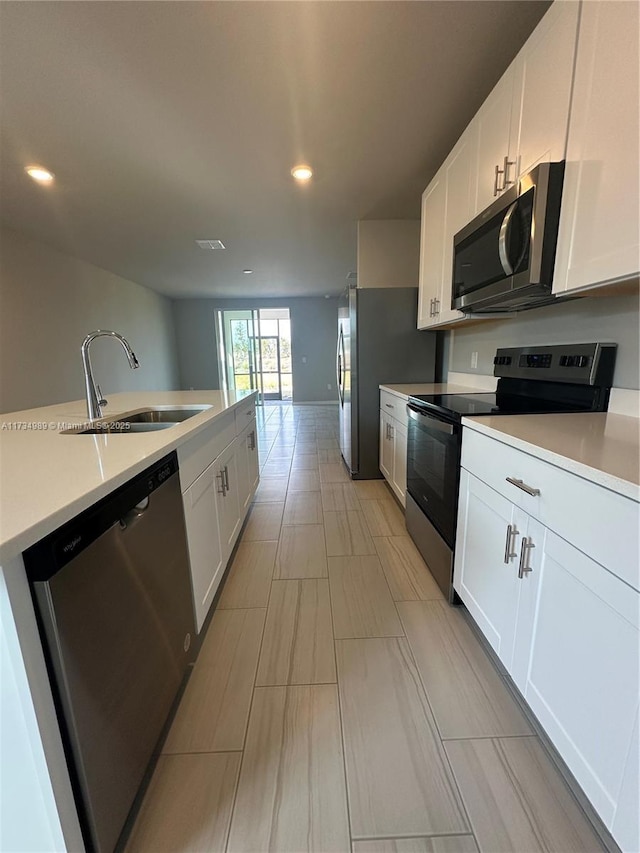 kitchen featuring white cabinetry, appliances with stainless steel finishes, and sink