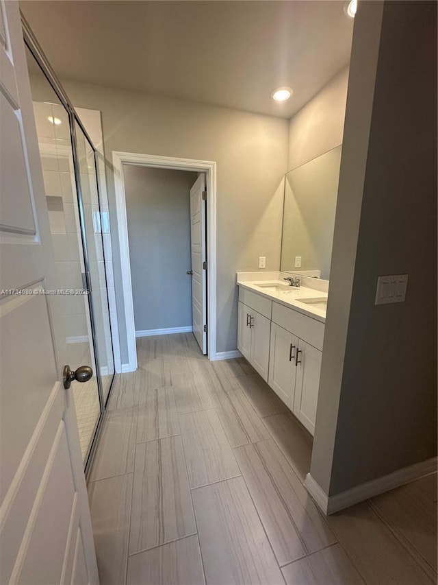 bathroom featuring vanity and an enclosed shower