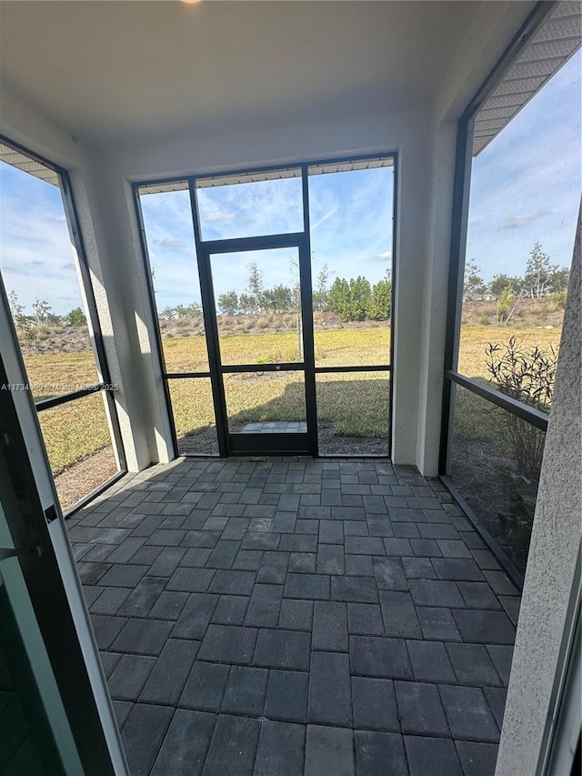 unfurnished sunroom featuring a rural view