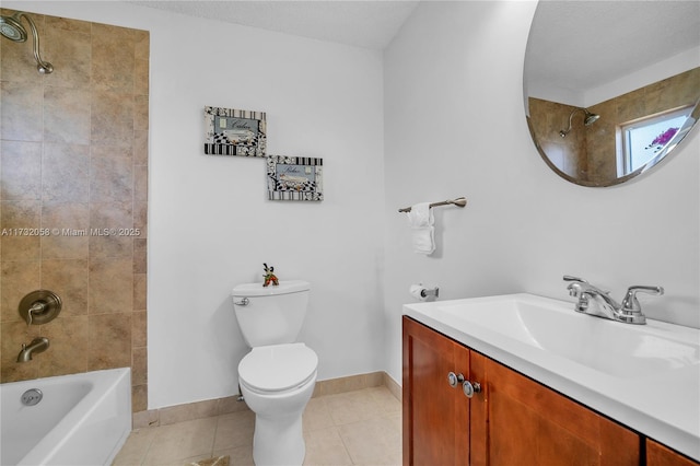 full bathroom with tile patterned flooring, vanity, tiled shower / bath, and toilet