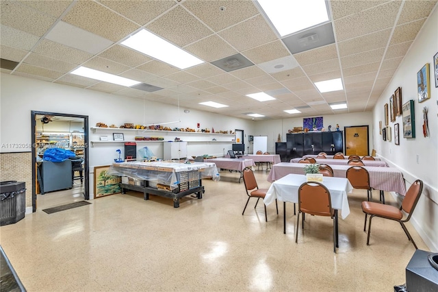 dining area featuring a drop ceiling