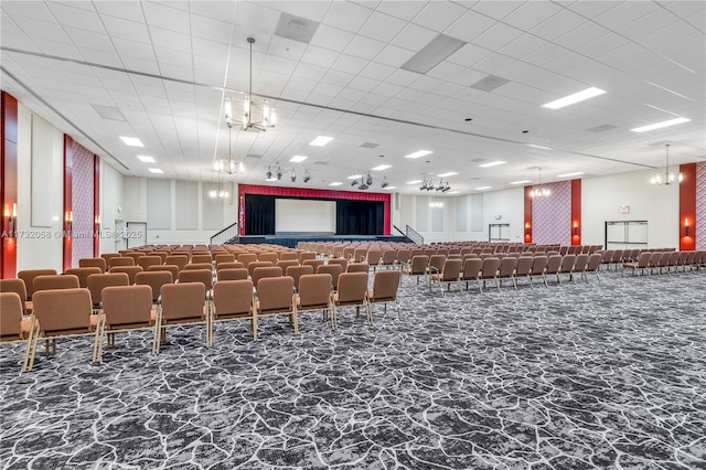 miscellaneous room with an inviting chandelier and a paneled ceiling