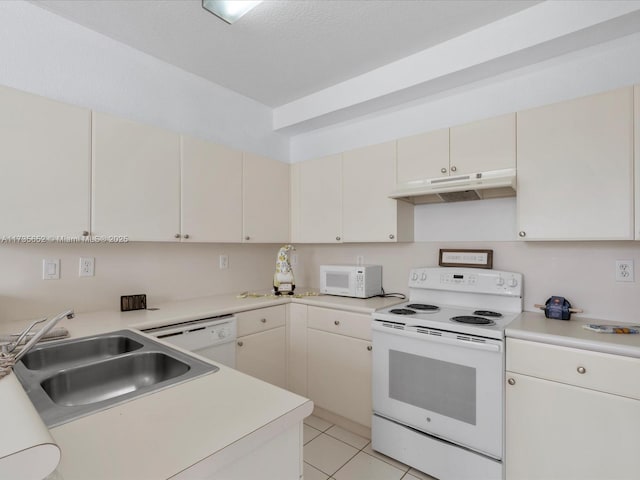 kitchen with sink, white appliances, and light tile patterned flooring