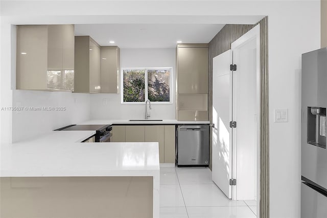 kitchen featuring appliances with stainless steel finishes, kitchen peninsula, sink, and light tile patterned floors