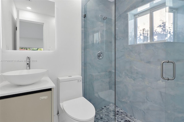 bathroom with vanity, toilet, and an enclosed shower