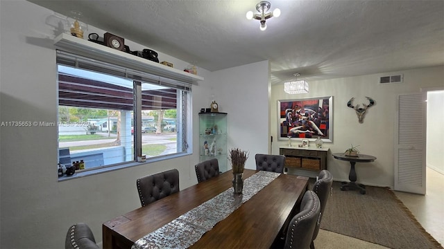 dining space featuring a textured ceiling