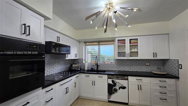 kitchen featuring white cabinetry, sink, decorative backsplash, and black appliances