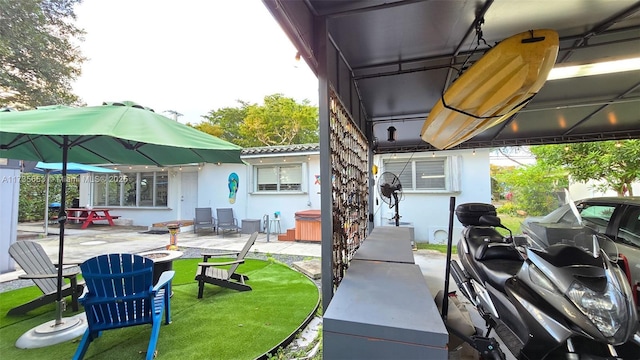 exterior space featuring an outdoor fire pit, a lawn, and a patio area