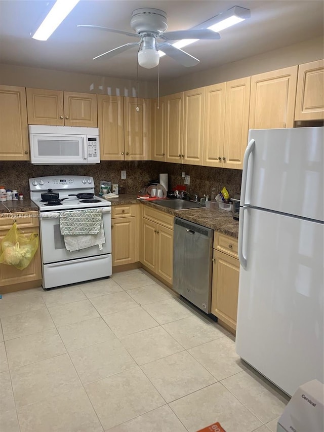 kitchen featuring tasteful backsplash, white appliances, sink, and light tile patterned floors