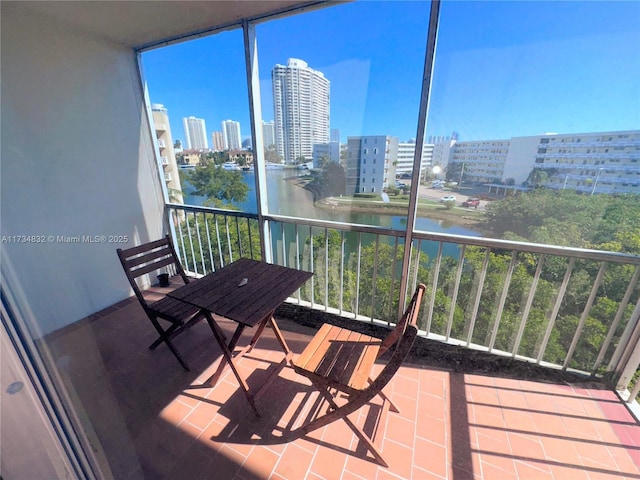 unfurnished sunroom featuring a water view