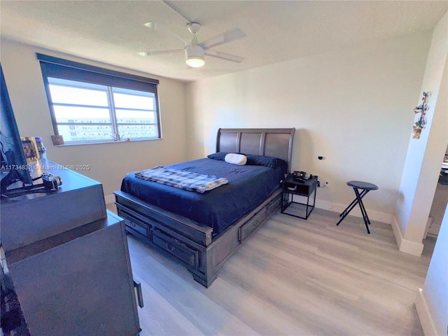 bedroom with light hardwood / wood-style flooring and ceiling fan