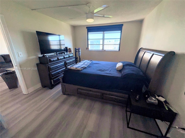 bedroom with wood-type flooring and ceiling fan