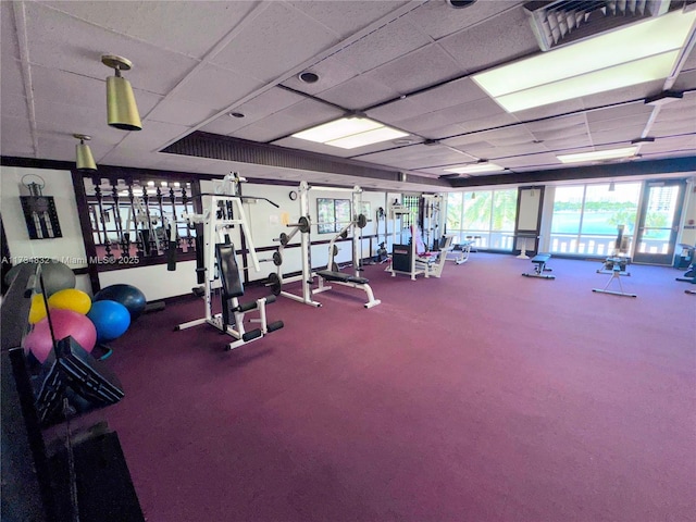 exercise room with a paneled ceiling