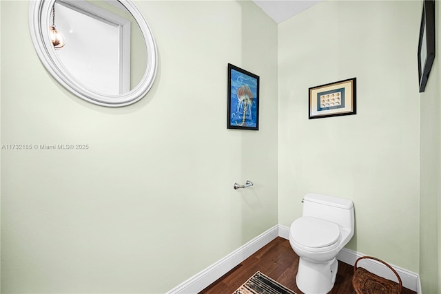 bathroom with toilet and hardwood / wood-style floors