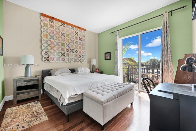 bedroom featuring access to outside and dark hardwood / wood-style floors