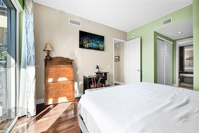 bedroom featuring wood-type flooring and a closet