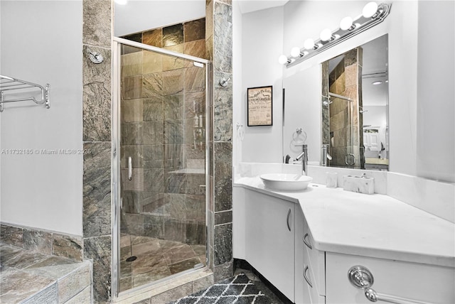 bathroom with a shower with door and vanity