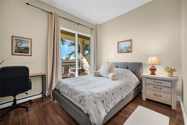 bedroom featuring access to outside and dark hardwood / wood-style floors