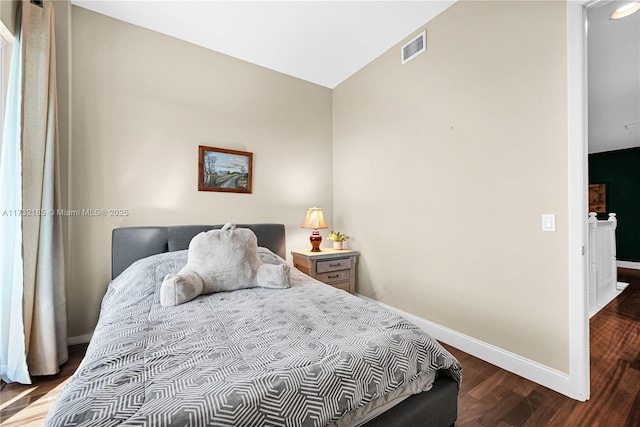 bedroom featuring hardwood / wood-style floors and vaulted ceiling