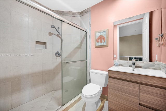 bathroom featuring walk in shower, vanity, and toilet