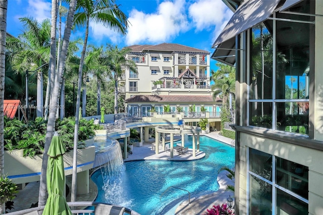 view of swimming pool with a patio and pool water feature