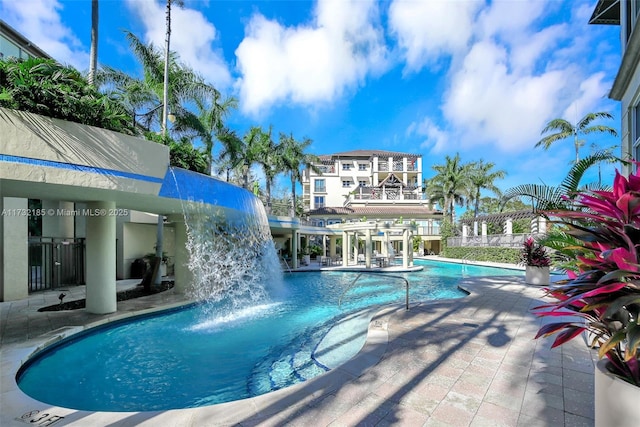 view of swimming pool with pool water feature