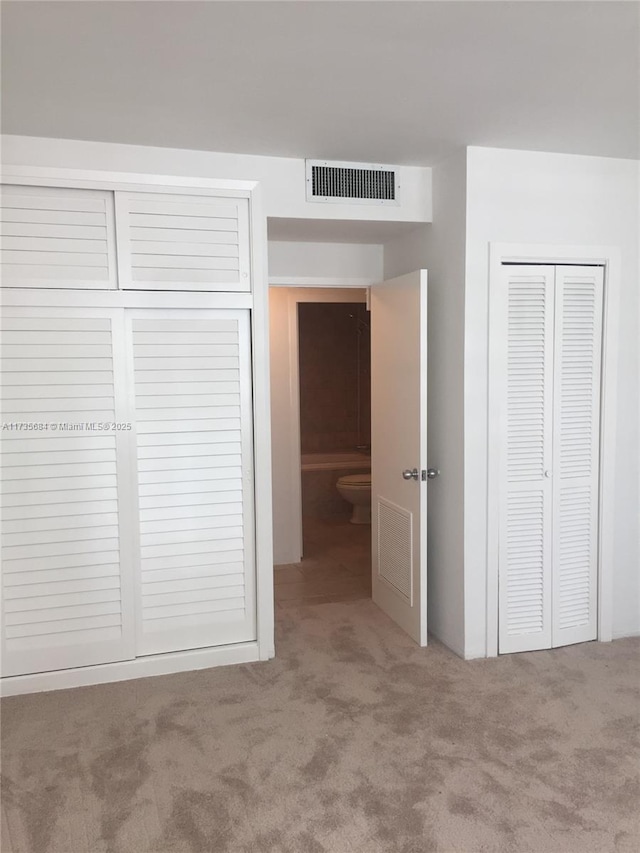 unfurnished bedroom with carpet floors and a closet