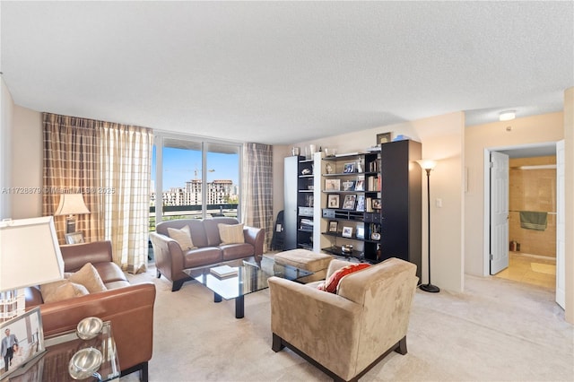 living area with a view of city, floor to ceiling windows, light carpet, and a textured ceiling