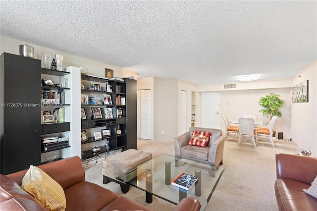 carpeted living room featuring a textured ceiling