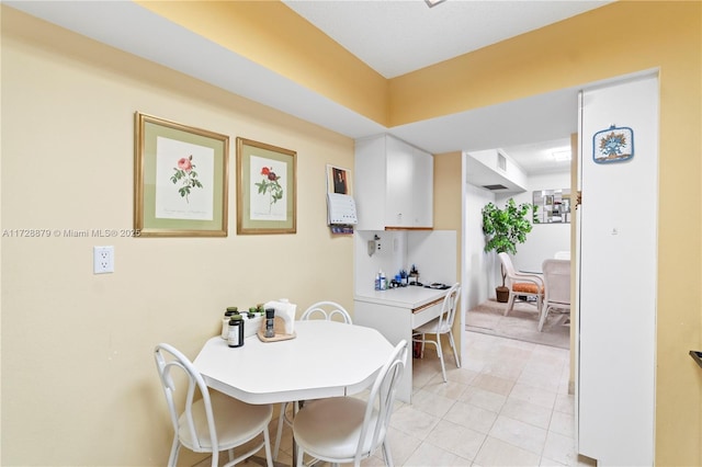 dining area featuring light tile patterned floors