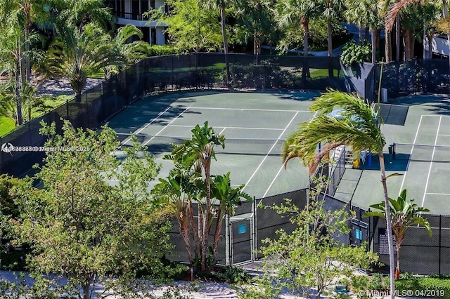 view of tennis court featuring fence