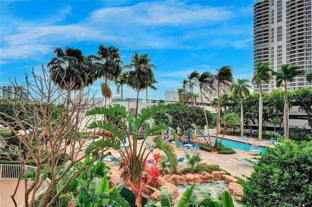 community pool featuring fence and a patio