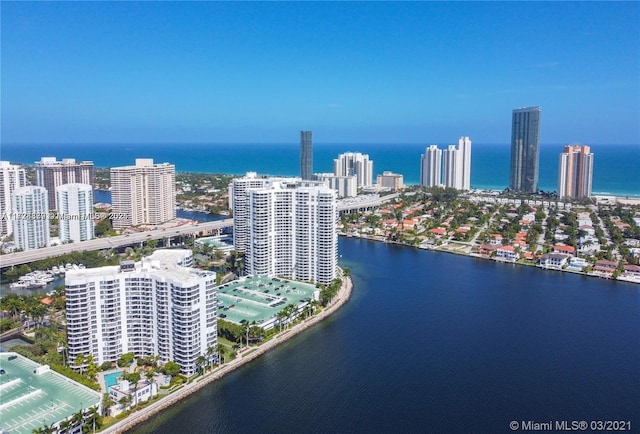 birds eye view of property featuring a water view and a city view