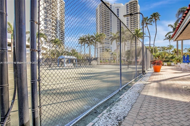 view of sport court with fence