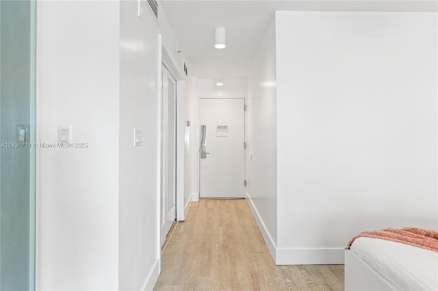 hallway with light wood-type flooring