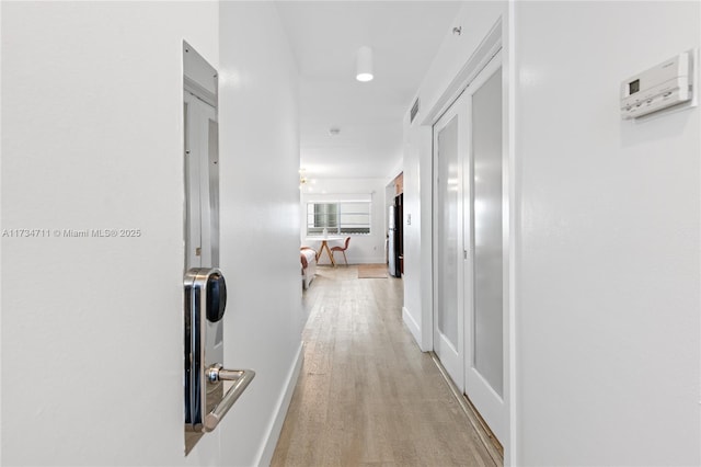 hall with light hardwood / wood-style flooring