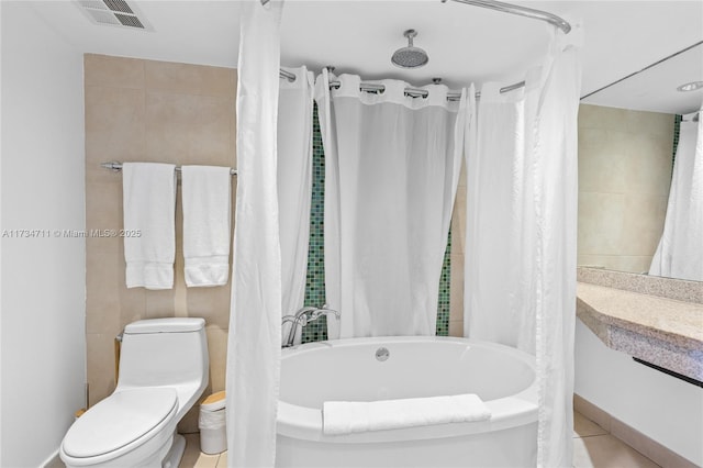 bathroom featuring shower / bath combination with curtain and toilet