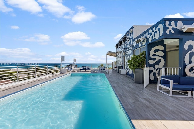 view of pool featuring a water view