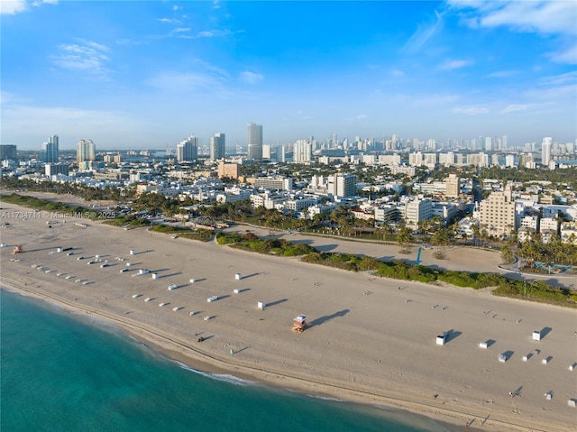 birds eye view of property with a water view and a view of the beach