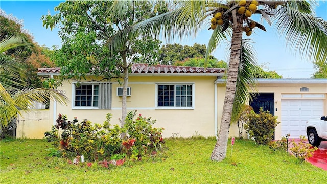 view of side of property with a garage and a lawn